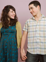 A teenage couple holding hands.