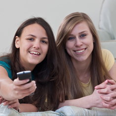 Two girls with a remote control.