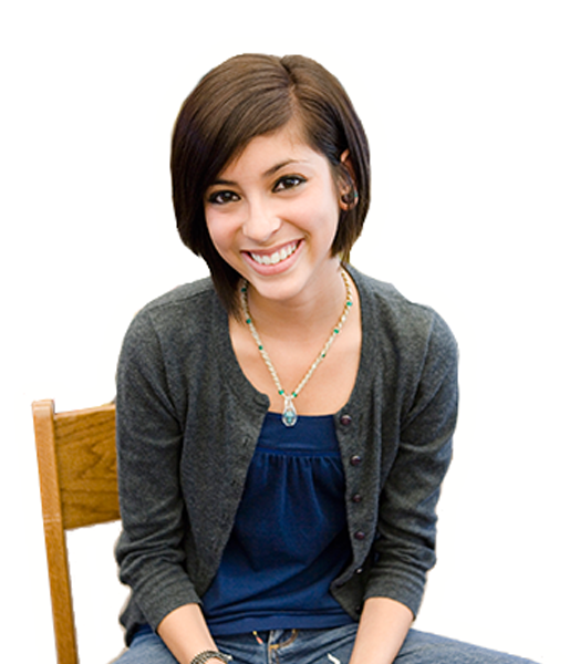 Girl sitting in chair and smiling.