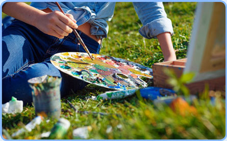 young girl painting outside