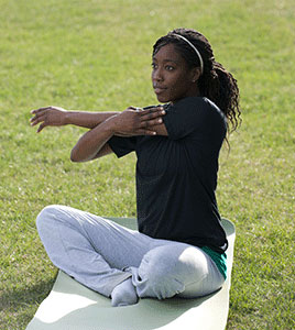 A girl doing a cross shoulder stretch