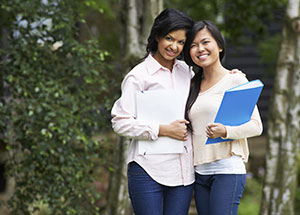 Two girls with their arms around each other.