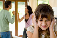 A girl covering her ears as her parents fight.