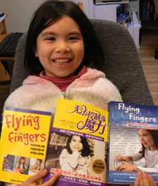 Adora Svitak holding books she has published